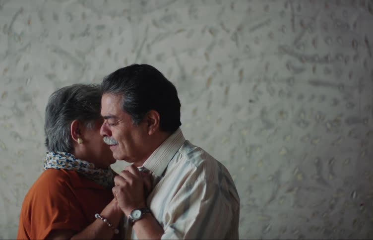 Elderly couple holding each other dancing together