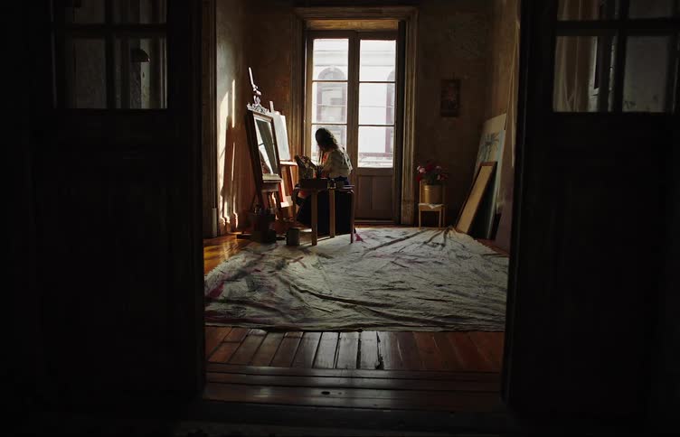 Mother and daughter sitting in a room facing an artistic whiteboard