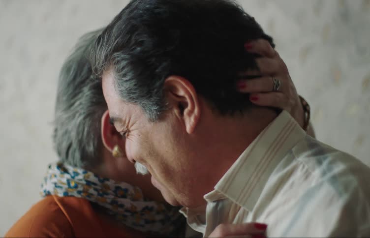Portrait of an elderly couple dancing with their faces side by side in a romantic way