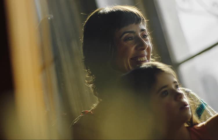 A mother and daughter laugh together