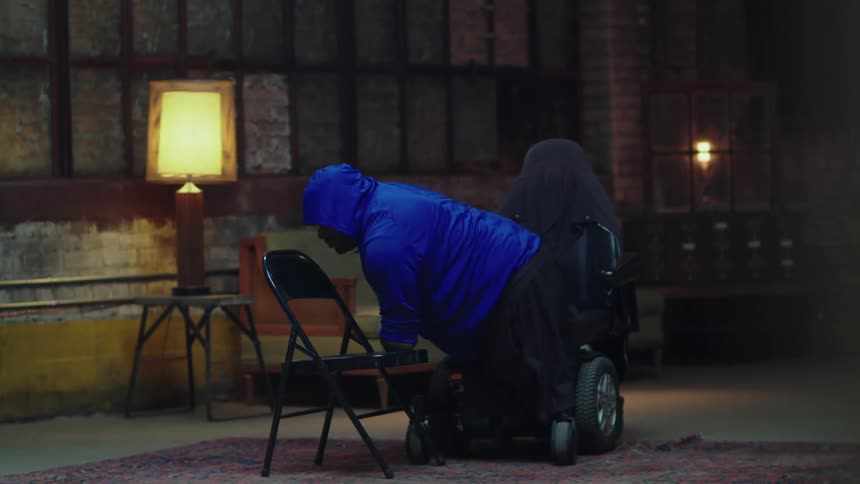 Man struggling to sit on a robotic chair because it has no legs