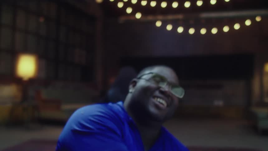 A man falls down as he is laughing