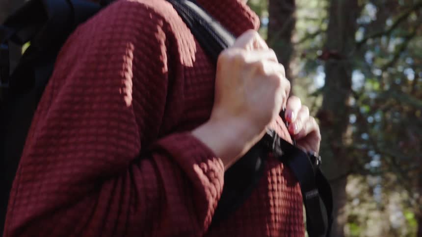 A woman is hiking in the woods