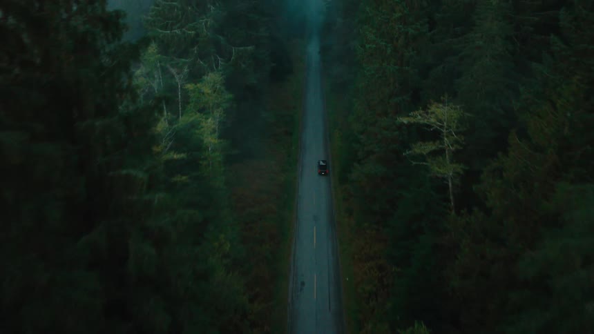 A car drives down the long road