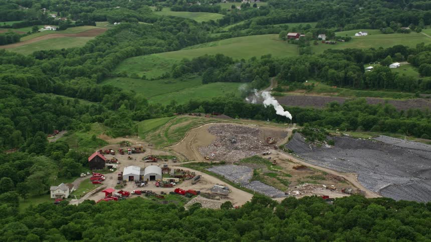 Aerial panorama of machinery on a hill in a stone farm