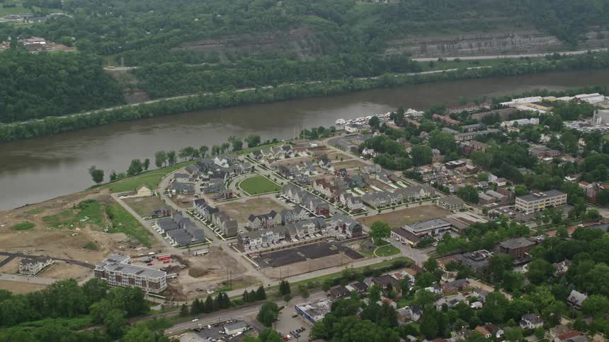 A small neighborhood sits next to the muddy river