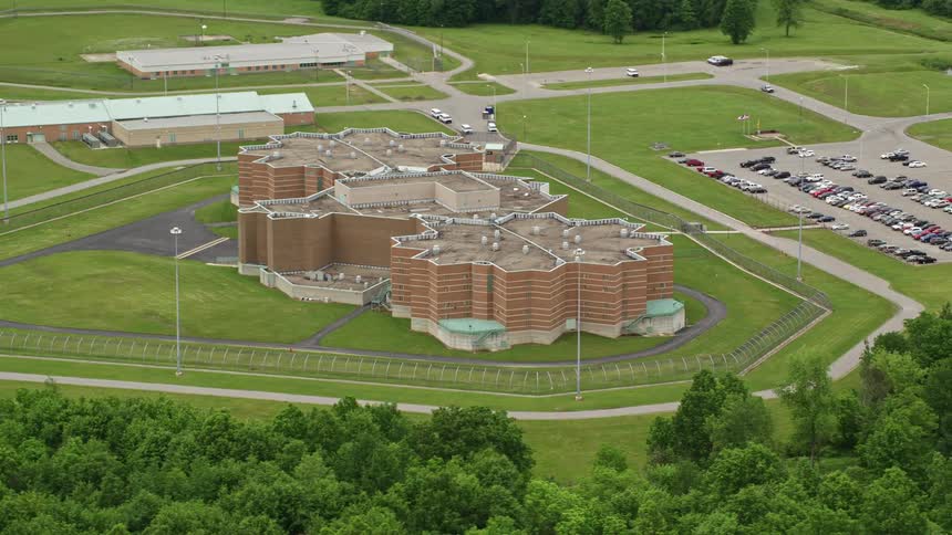 A large complex is behind a fence