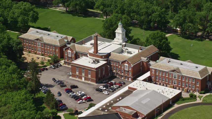 Aerial panorama of a complex with a parking lot and cars around