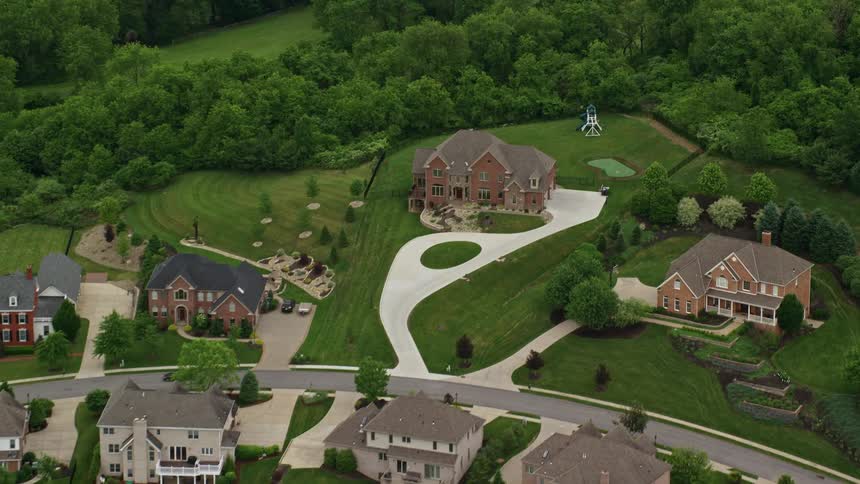 Aerial view of a suburban neighborhood surrounded by wellmaintained lawns