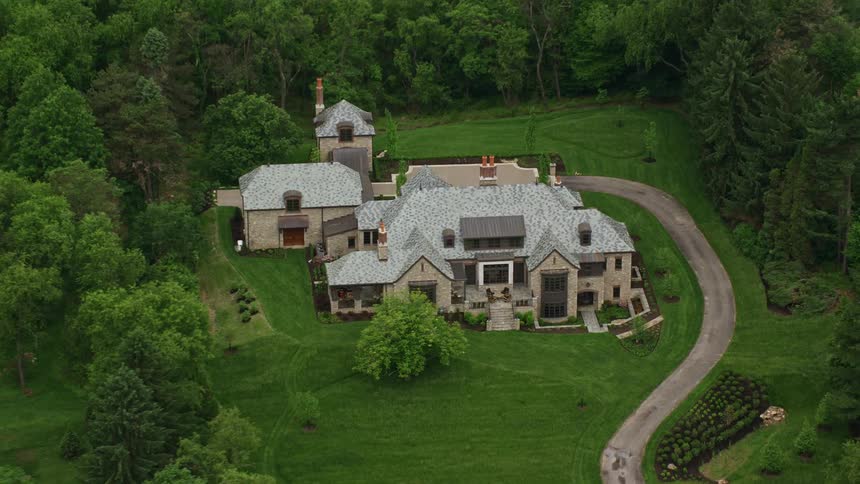 The estate of a mansion nestled in the middle of a forest