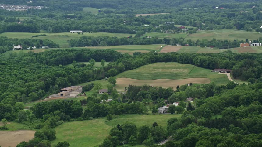 An aerial view of a golf course in a green vegetation community