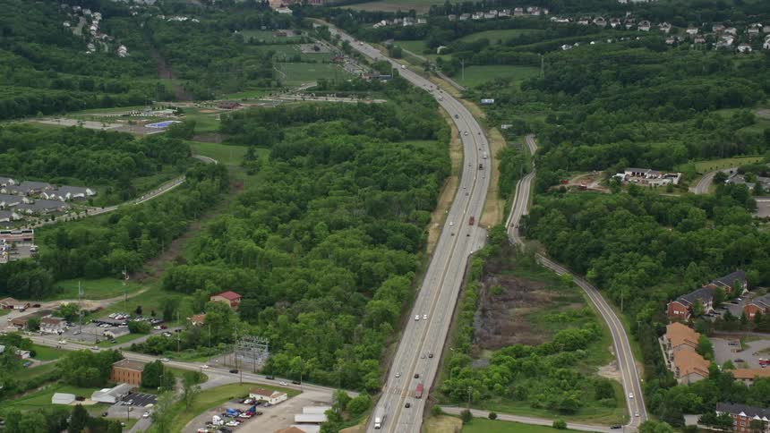 Aerial panorama of a highway passing through cities with vegetation