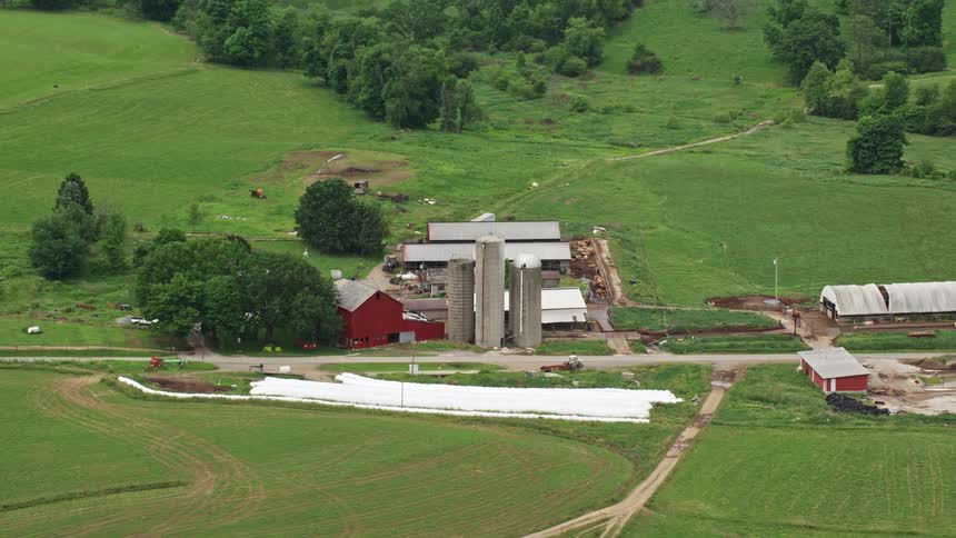 The silos are on the side of the barn