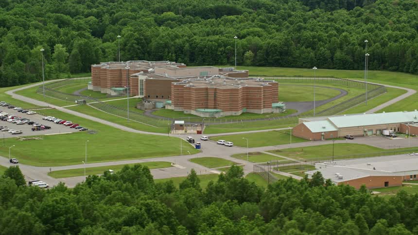 An aerial clip of a building closer to the forest