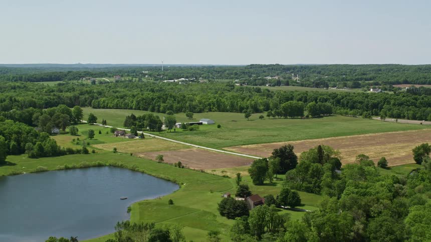 A farm is by the forest