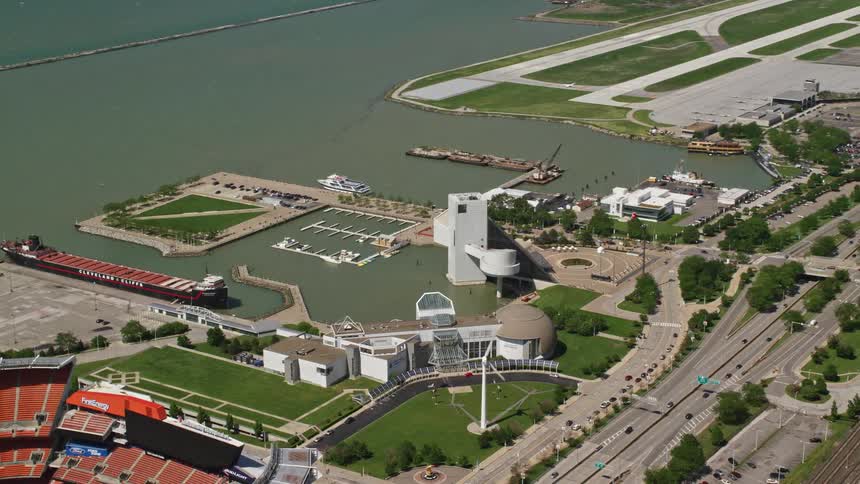 Aerial panorama of a highway in a seaside city with public places stadium and airstrip