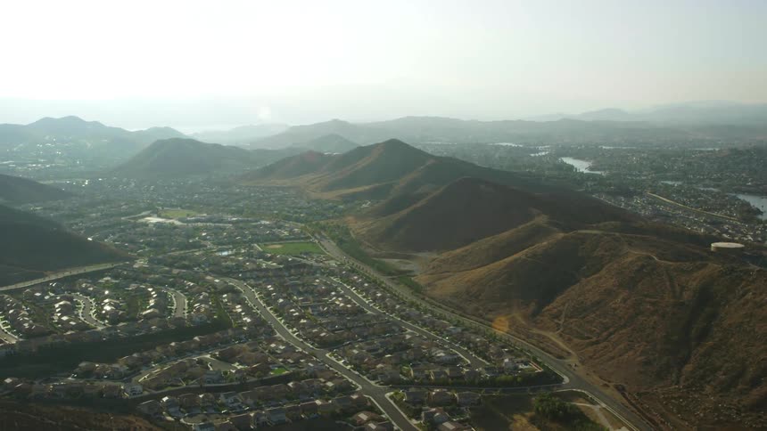 Aerial of a large neighborhood of houses in a mountainous area