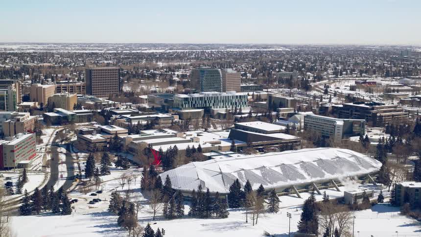 A snow-covered sports complex on a university campus in the winter
