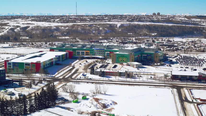 Aerial fly-by of a children's surrounded by snow in the winter