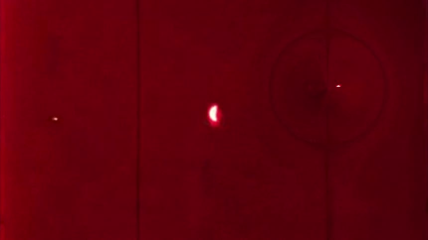 Microscopic view of a red fluid with microorganism expanding