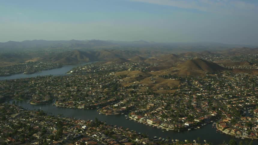 Aerial panorama of an urban city built on hills and mountains and with river channels around it
