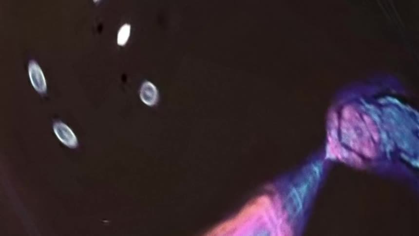 A computer generated effect with throbbing colors and moving orbs