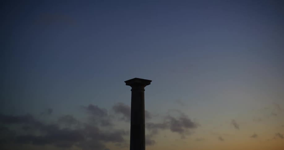 The sun is setting on the pillar