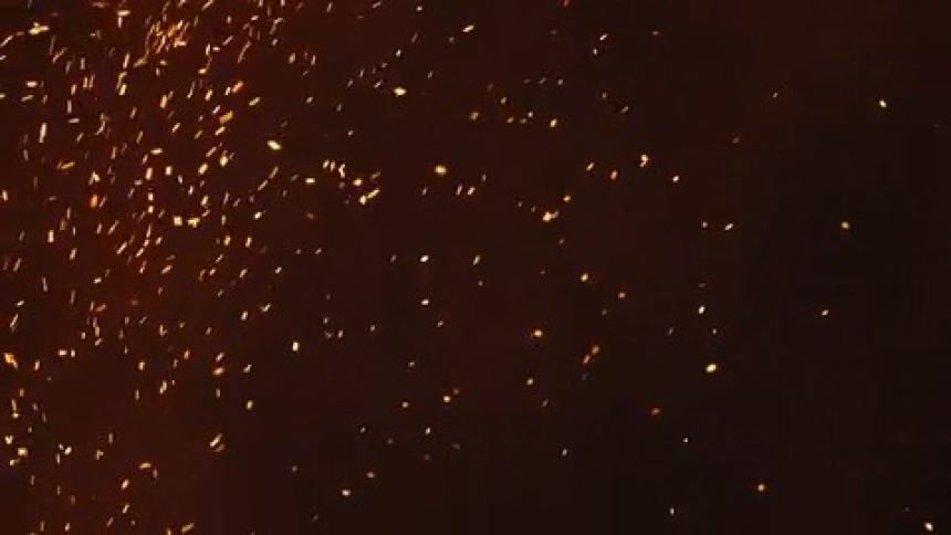 Flames and ashes going in the air at night