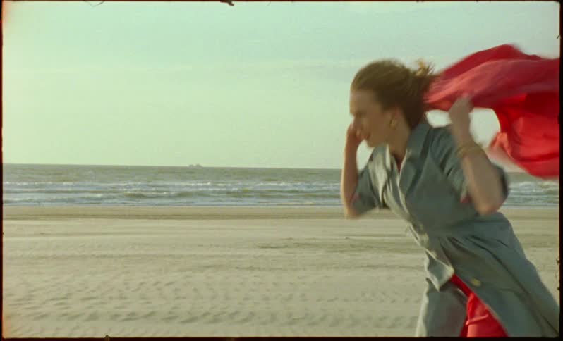 A woman acts like she has a cape and runs off