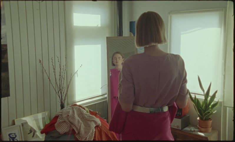A young woman seems sad that she doesnt like her outfit