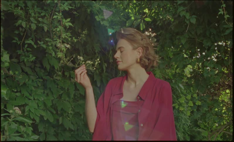 Woman is holding flowers from the tree during spring