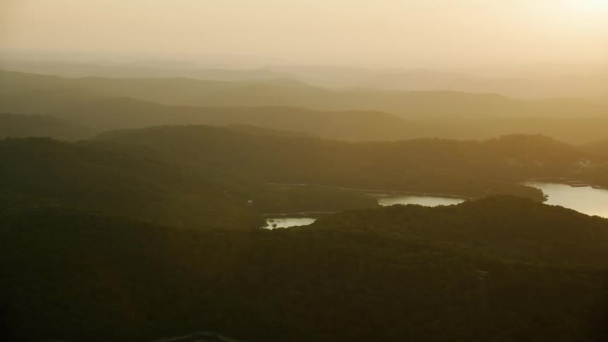 Fog lies over mountains covered in forests