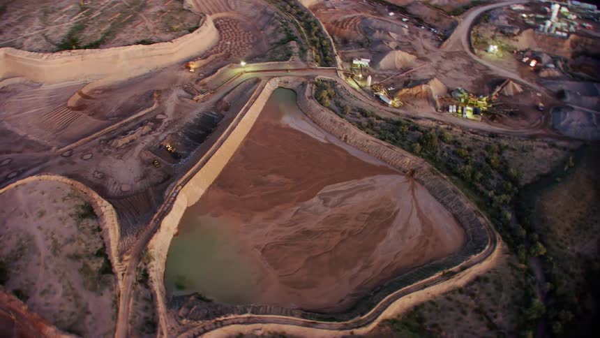 An aerial clip of a dam in a community