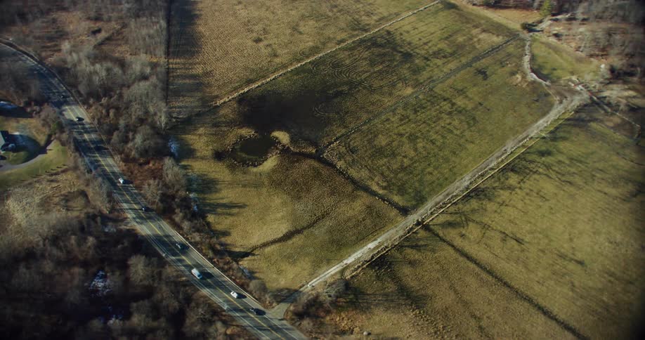 Aerial panorama of a rural area with a highway in the middle with vehicle traffic
