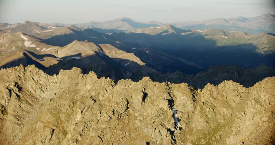 An aerial footage of mountains covered with fog