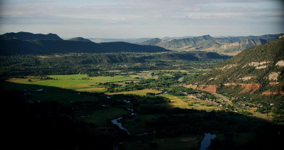 Aerial view of a rural plain surrounded by mountains