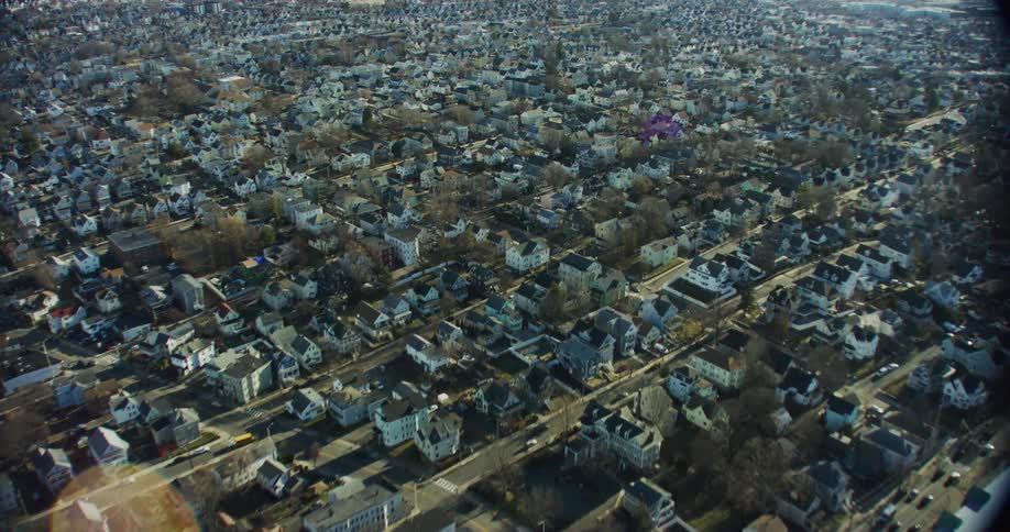 Traffic passes along streets through a large residential neighborhood