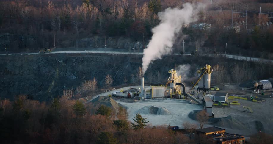 Smoke escapes from a chimney at a small refinery