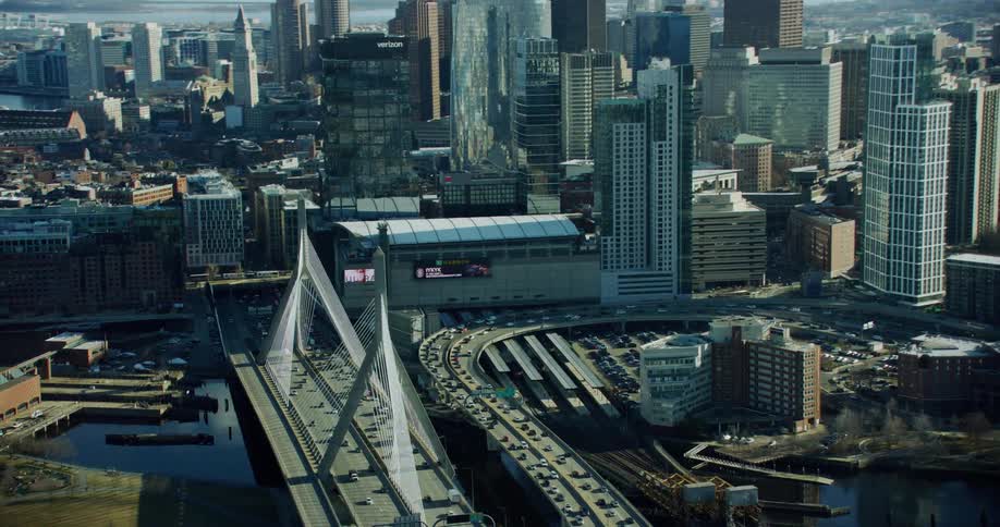 Aerial panorama of a metropolis with a skyscraper and a huge bridge over a river with vehicle traffic