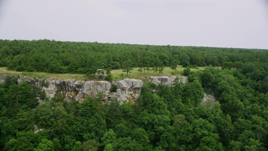 Aerial panorama of forests in the mountains with an observation deck on a cliff