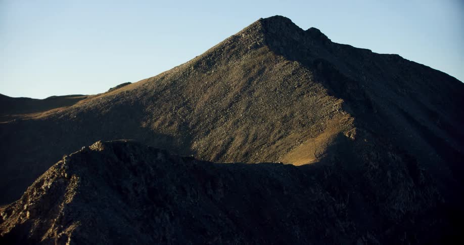 Rocky mountain with black sand on a cloudless blue sky morning