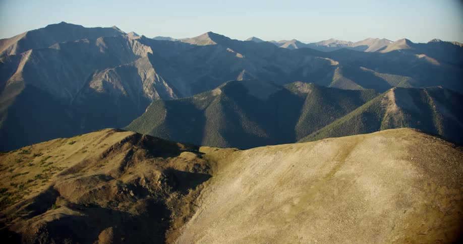 Aerial landscape of hills and mountains in a cloudless blue sky