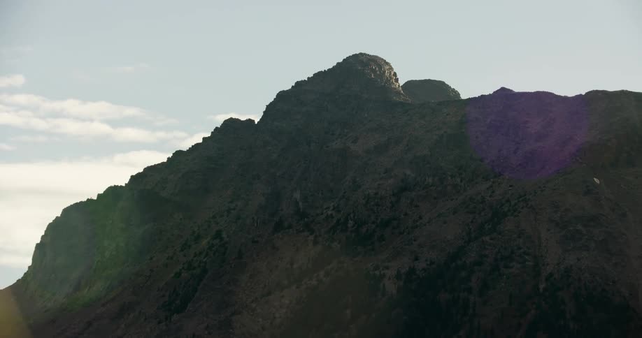 Sun is shining on the mountain tops during the daytime