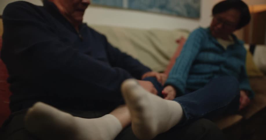A man massages his wifes feet and legs