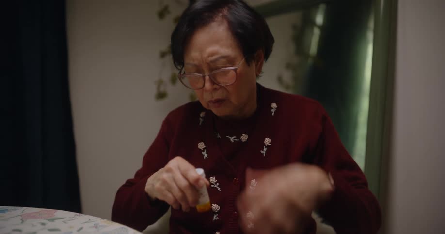 A woman hurts her hand trying to open a medicine bottle