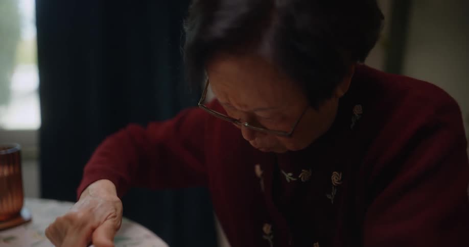 A woman is trying to close the cap on a medicine bottle