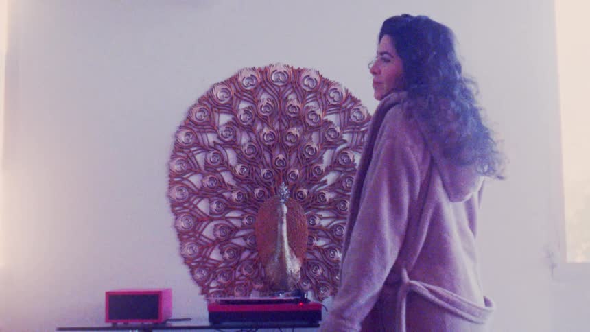 A young happy woman dancing at home