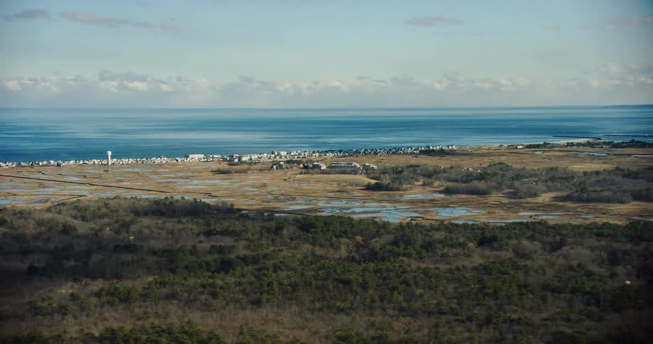Aerial panorama of natural fields by the blue sea