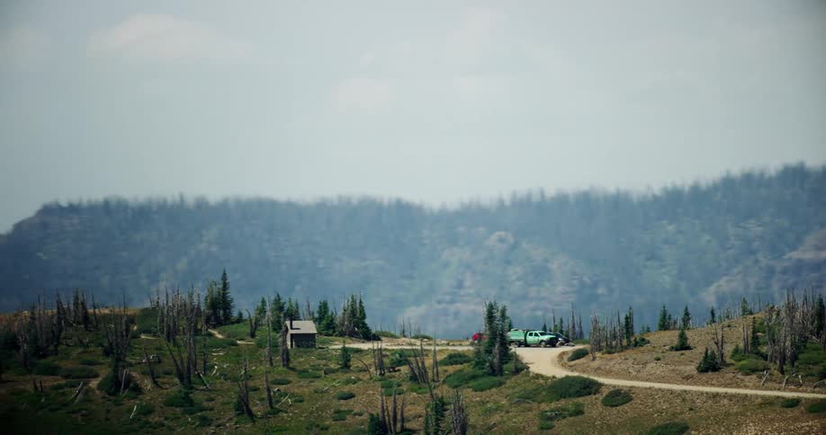 Aerial view of a small cabin atop a mountain