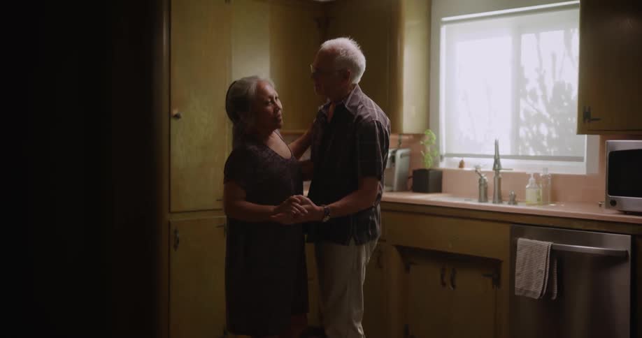 Happy older couple dancing in the kitchen